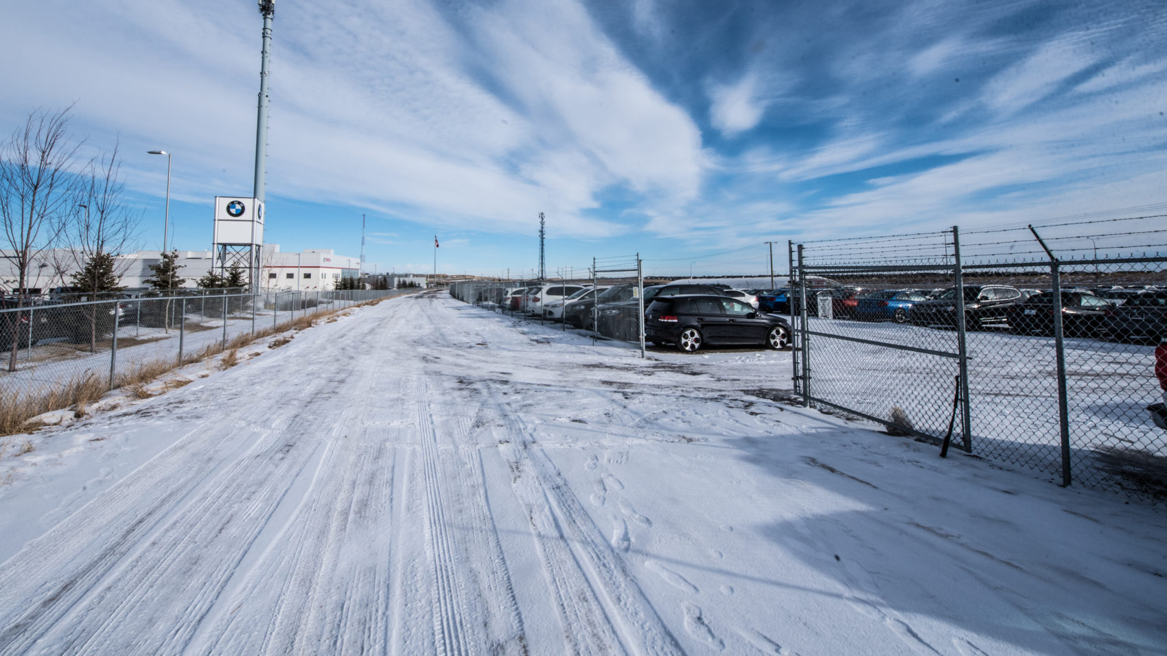 View through chain link fence of Stoney Trail Auto Storage.