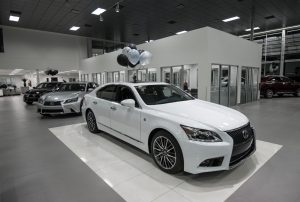 Showroom with a white Lexus with balloons on the roof at Lexus of Royal Oak.