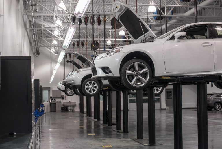 Vehicles hoisted in garage service area at Lexus of Royal Oak.