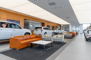 Customer seating area with cars surrounding in the showroom at Carter Cadillac.