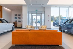 Orange couch sitting area in showroom at Carter Cadillac.