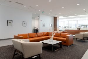 Service customer waiting area with orange leather chairs.