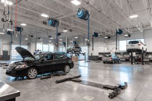 Garage with cars being serviced at South Trail Nissan.