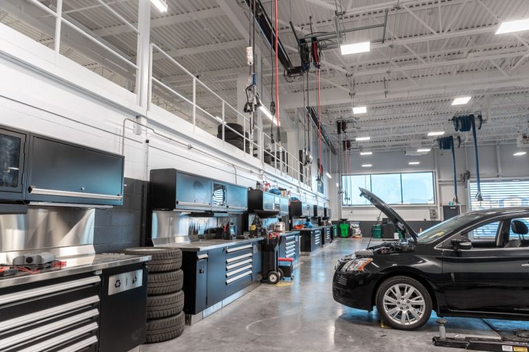 Nissan car getting serviced in the back garage at South Trail Nissan.